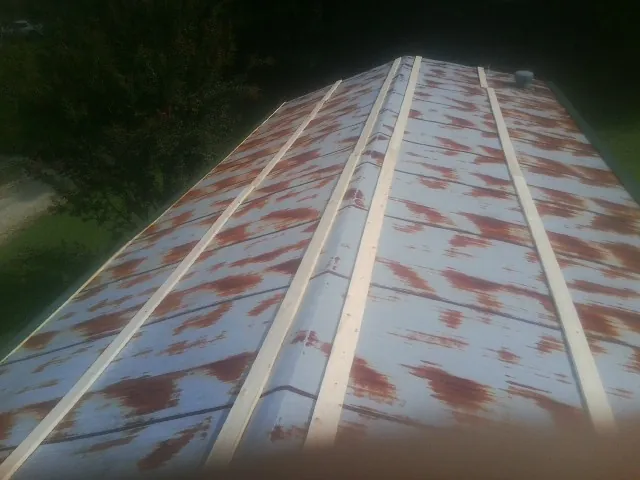 Rusted metal roof panels with new wood purlins before replacement — Storm Damage Roof Repair in Epworth by Roofing Brothers