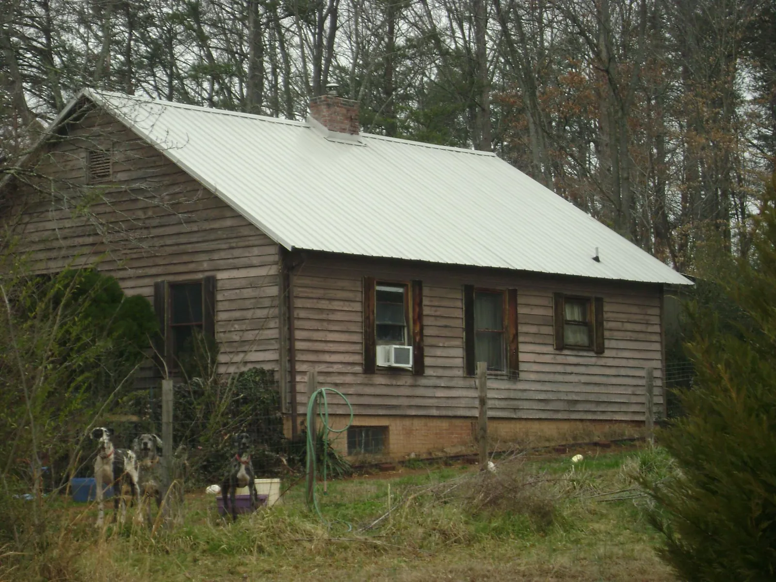 White metal roof on an old wood sided farmhouse, from a Metal Roof Installation job in Epworth